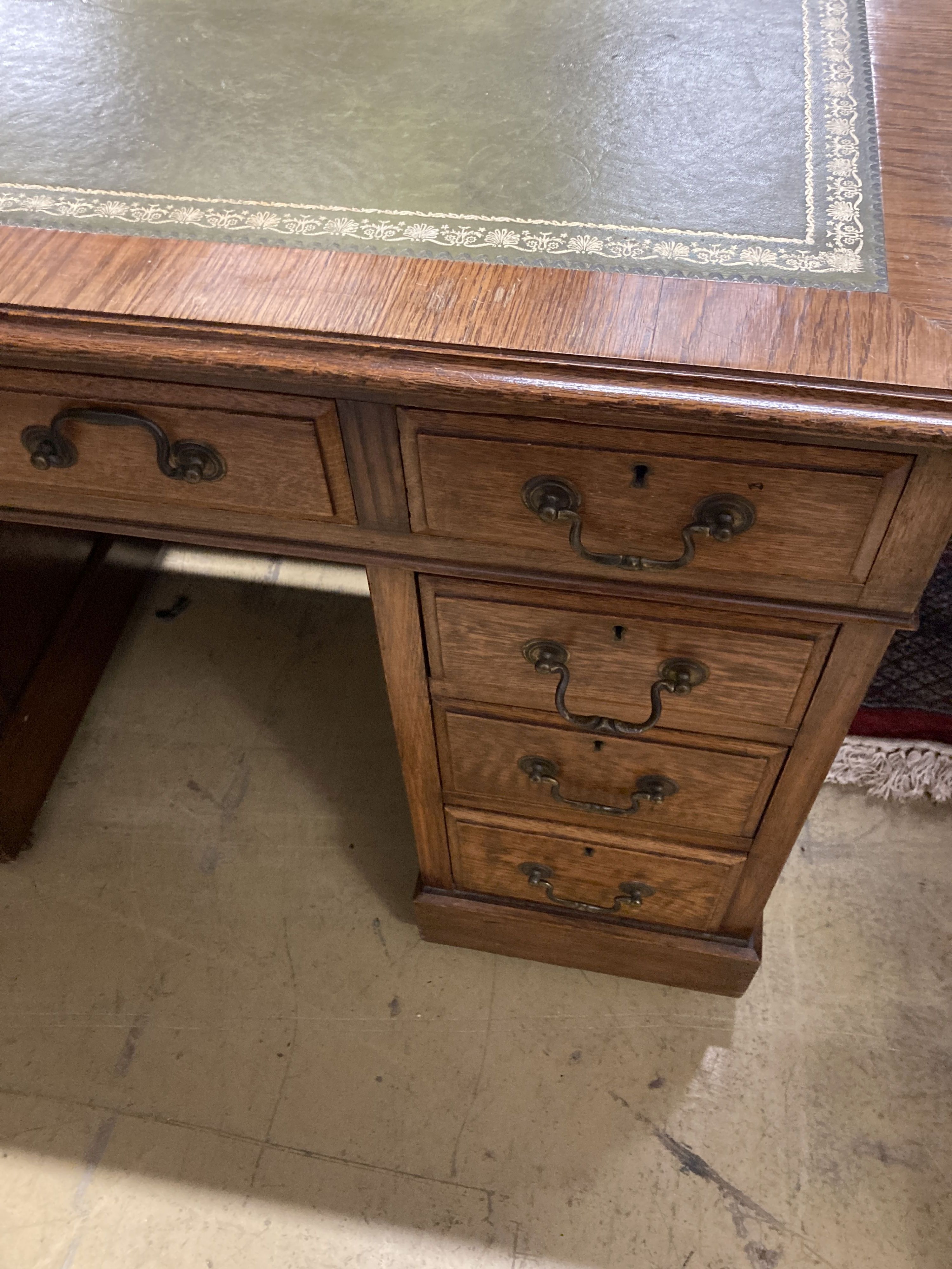 A small Victorian style oak pedestal desk, width 107cm, depth 57cm, height 76cm